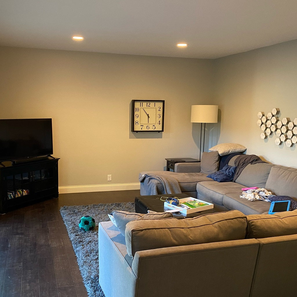 empty living room wall with tv and couch