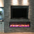 stone wall with electric fireplace and tv