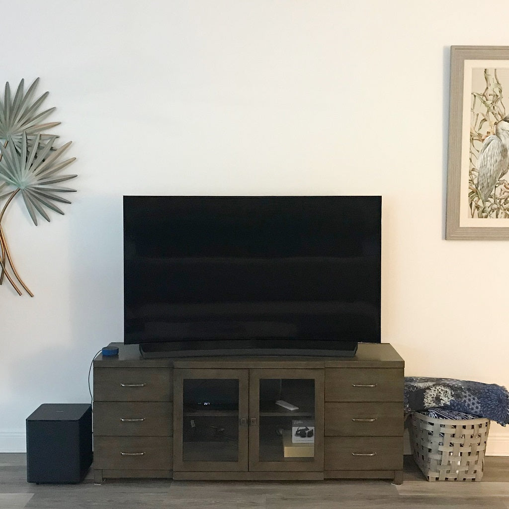 blank wall with tv and tv console