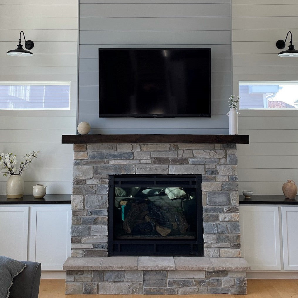 living room with beautiful new fireplace with stone and shiplap and tv