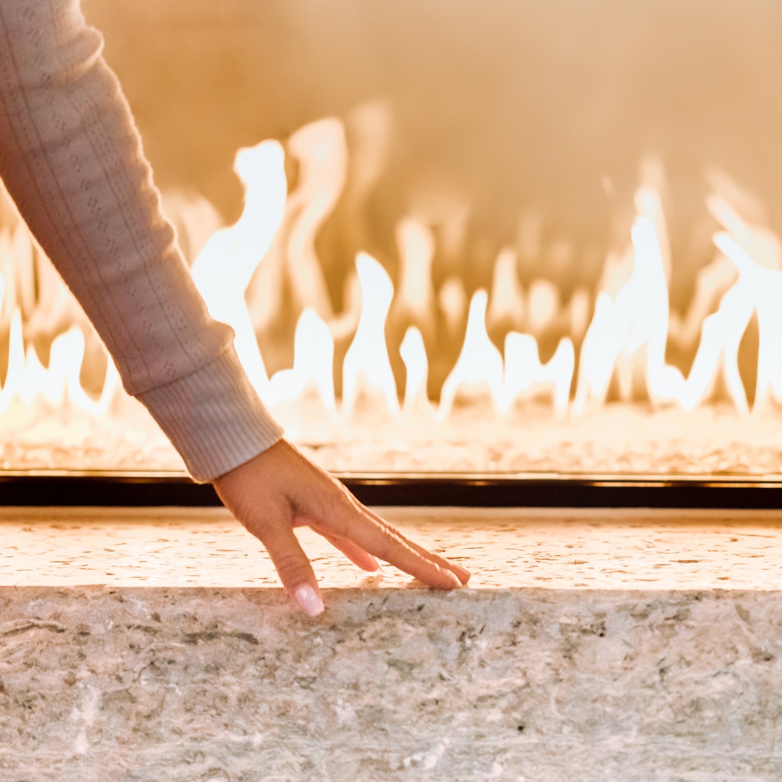 woman's hand touching near fireplace