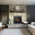remodeled gas fireplace with gray stone wall, gray hearth, brown mantel, clock, couch, rug, candles