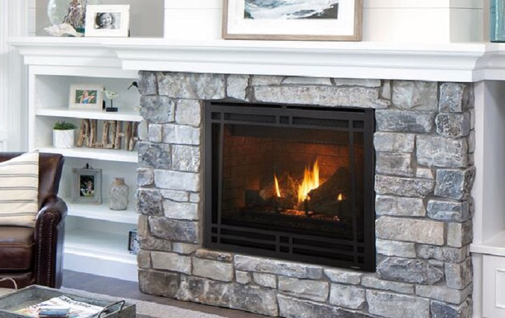 a traditional gas fireplace in living room with mantel, stone and shelves