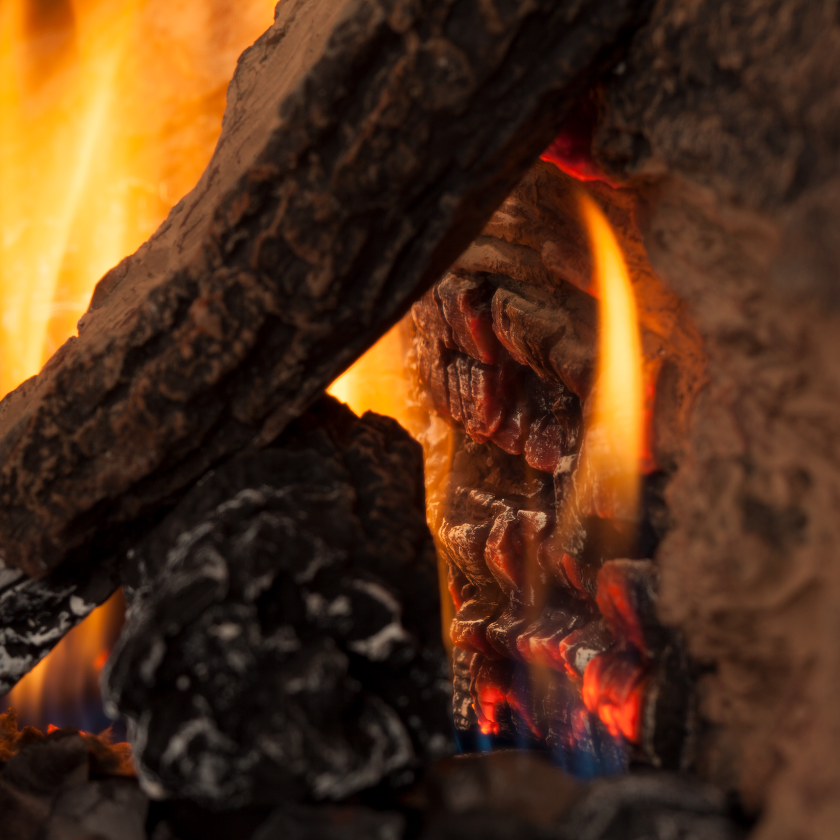 gas fireplace with timber logs and flame