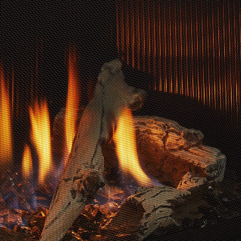 gas fireplace with fluted black glass panels and driftwood logs
