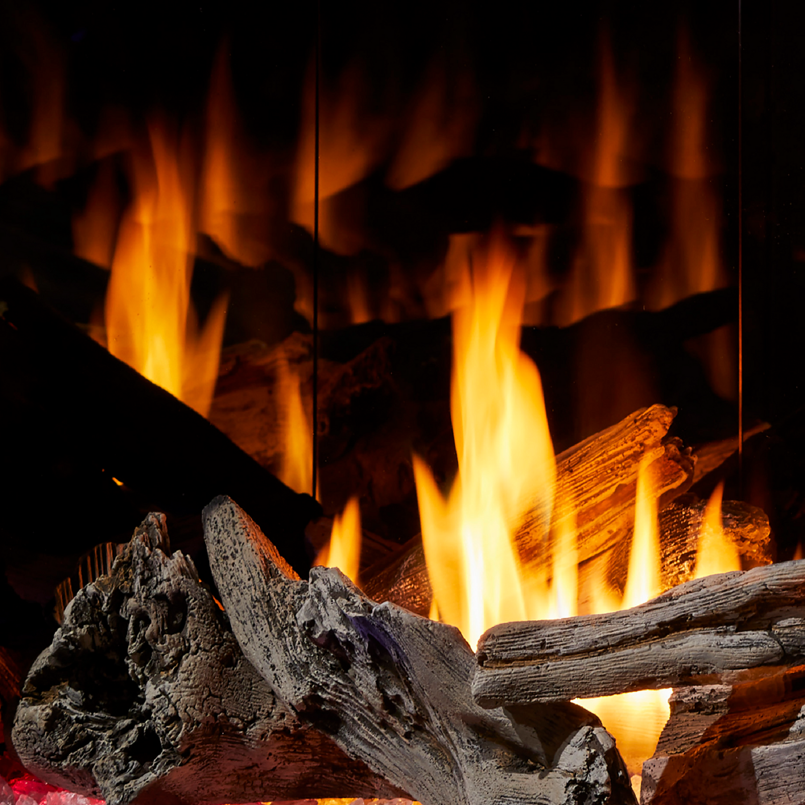 custom gas fireplace with logs and mirror panel